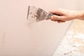 Stripping old paint from the wall. Renovation and painting of walls in the apartment Royalty Free Stock Photo