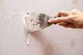 Stripping old paint from the wall. Renovation and painting of walls in the apartment Royalty Free Stock Photo