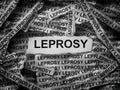 Strips of newspaper with the words Leprosy typed on them. Black and white