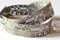 Strips of old punched tape on a white surface Royalty Free Stock Photo