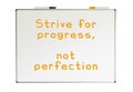 Strive for progress, not perfection, written on a whiteboard