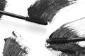 Stroke of black mascara with applicator brush close-up, isolated on white background. Royalty Free Stock Photo