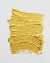 Strokes of gold acrylic paint isolated on white Royalty Free Stock Photo