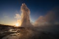 Strokkur geyser eruption in Iceland. Fantastic colors shine through the steam. Beautiful pink clouds in a blue sky Royalty Free Stock Photo