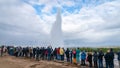 The Strokkur geyser in Iceland is erupting while tourists are looking Royalty Free Stock Photo