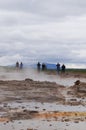 Unidentified tourists waiting for eruption of Strokkur Geysir,Iceland. Royalty Free Stock Photo