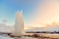 Strokkur geysir wowing the small group of tourists in Iceland