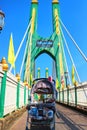 Stroller put a cute pug dog on a beautiful sky background bridge in the morning