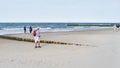 Strollers on the beach of Kolobrzeg on the Polish Baltic Sea Royalty Free Stock Photo