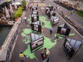 Strolling tourists view photo exhibit in the Berges du Seine, Paris