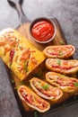 Stromboli Pizza homemade dough loaded with meats, sauce and cheese and rolled up and baked closeup on the wooden board. Vertical Royalty Free Stock Photo