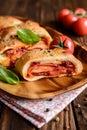 Stromboli stuffed with cheese, salami, green onion and tomato sauce Royalty Free Stock Photo