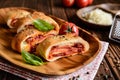 Stromboli stuffed with cheese, salami, green onion and tomato sauce Royalty Free Stock Photo