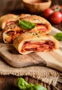 Stromboli stuffed with cheese, salami, green onion and tomato sauce Royalty Free Stock Photo