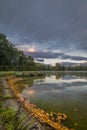 Stromovka park with trees forest and pond Bagr in autumn morning