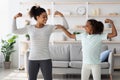 Strong african american mother and daughter showing their muscles Royalty Free Stock Photo