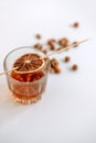 Strong alcohol whisky in a glass cup with a slice of dried orange and nuts Royalty Free Stock Photo