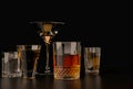 Strong alcoholic drinks, glasses and glasses, in the presence of whiskey, vodka, rum, tequila, brandy, cognac. on a dark old backg Royalty Free Stock Photo