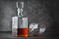 Strong alcoholic drink cognac in lying sniffer glass and crystal decanter