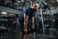 Strong athlete with dumbbells, training in gym