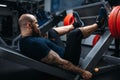 Strong athlete on exercise machine with barbell