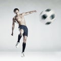 Strong athlete kicking the ball Royalty Free Stock Photo