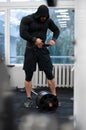 strong athlete man in hoodie preparing for heavy weight lifting training in gym with barbell wearing safe weightlifting Royalty Free Stock Photo