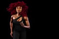 A strong athletic afro american woman on black background wearing in sportswear, fitness and sport motivation. Sport Royalty Free Stock Photo