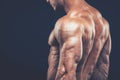 Strong athletic man back on dark background Royalty Free Stock Photo