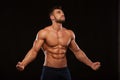 Strong Athletic Man Fitness Model Torso showing six pack abs. isolated on black background with copyspace Royalty Free Stock Photo