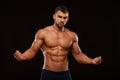 Strong Athletic Man Fitness Model Torso showing six pack abs. isolated on black background with copyspace Royalty Free Stock Photo