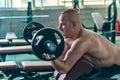 Strong athletic man make exercise with the preacher curls