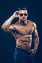 Strong athletic man in sunglasses on black Royalty Free Stock Photo