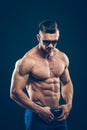 Strong athletic man in sunglasses on black Royalty Free Stock Photo