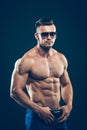 Strong athletic man in sunglasses on black Royalty Free Stock Photo