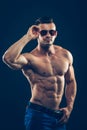 Strong athletic man in sunglasses on black Royalty Free Stock Photo