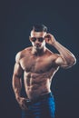 strong athletic man in sunglasses on black background Royalty Free Stock Photo