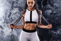 A strong athletic woman on black background wearing in white sportswear, fitness and sport motivation. Sport concept Royalty Free Stock Photo