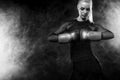 A strong athletic, woman boxer, boxing at training on the black background. Sport boxing Concept with copy space. Royalty Free Stock Photo