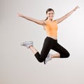 Strong athletic woman jumping in mid-air