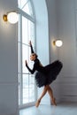 strong ballerina in black tutu ballet skirt and leotard