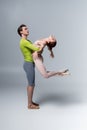 strong ballet dancer lifting ballerina in
