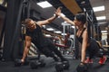 Strong and Beautiful Athletic Fitness Couple in Workout Clothes Doing Push Up Exercises and Giving Each Other a High Royalty Free Stock Photo