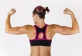 Strong Beautiful fitness woman flexing her arm and back muscles