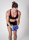 Strong Beautiful fitness woman lifting dumbbell weights Royalty Free Stock Photo