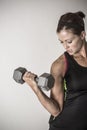 Strong Beautiful fitness woman lifting dumbbell weights Royalty Free Stock Photo