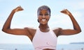 Strong black woman flexing arms, muscle and body power, fitness and wellness in urban Jamaica outdoors. Portrait proud Royalty Free Stock Photo