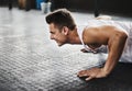 Strong bodies need a strong mindset. a young man doing pushups in a gym. Royalty Free Stock Photo