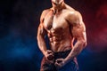 Strong bodybuilder man in military pants with perfect abs, shoulders, biceps, triceps, chest