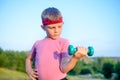 Strong Boy in an Outdoor Exercise Lifting Dumbbell Royalty Free Stock Photo